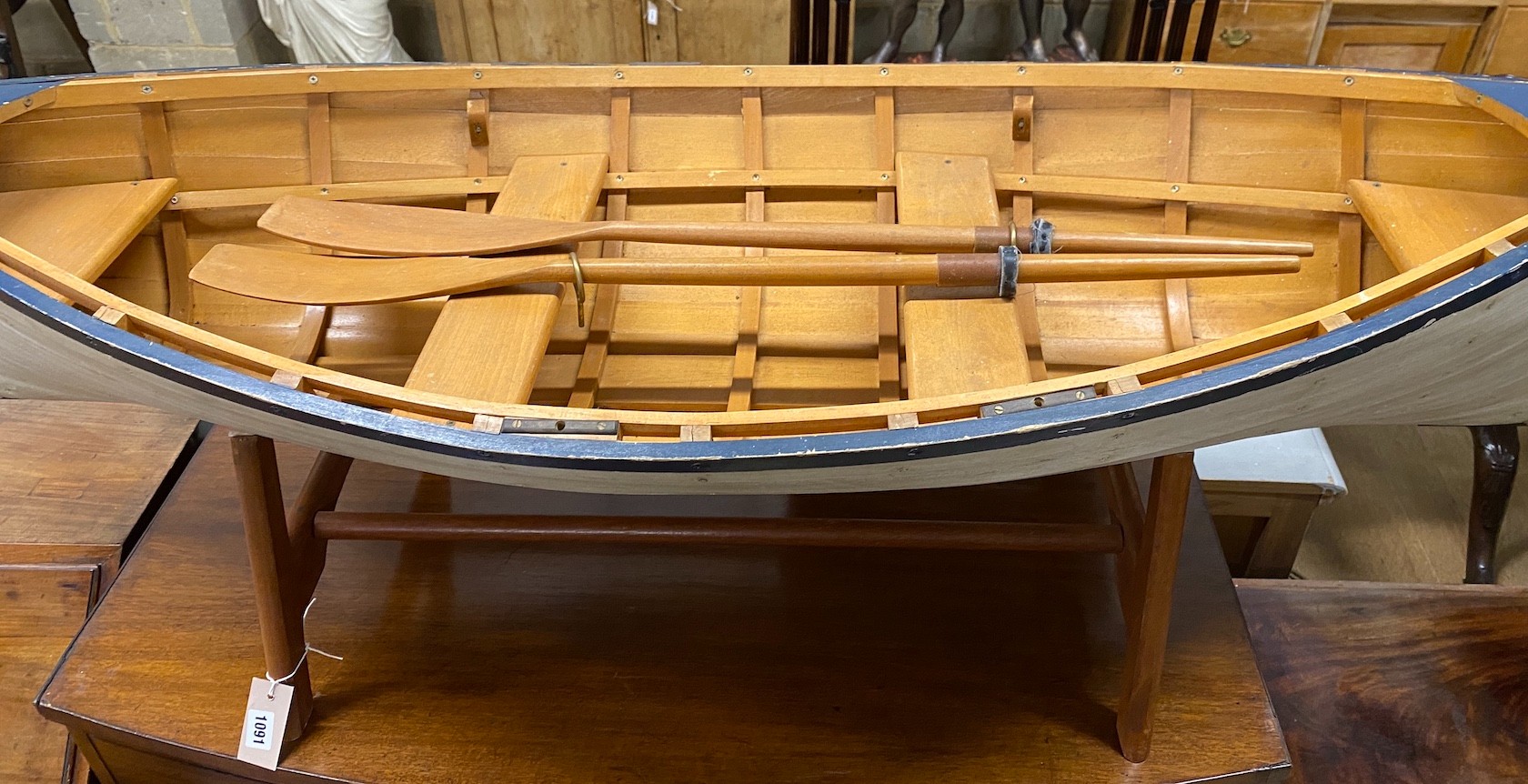 A model clinker built rowing boat with oars and stand, length 150cm